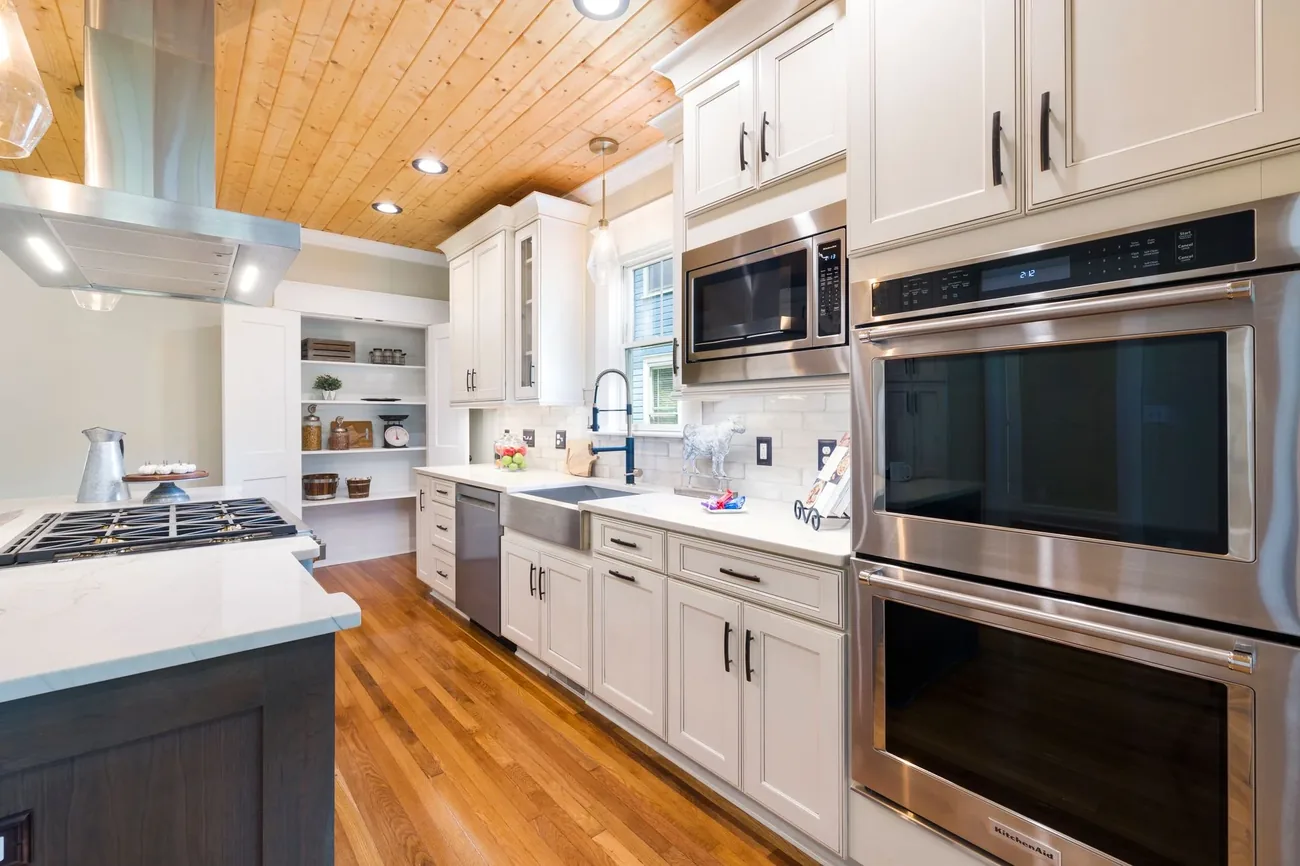A white shaker kitchen under a timber ceiling