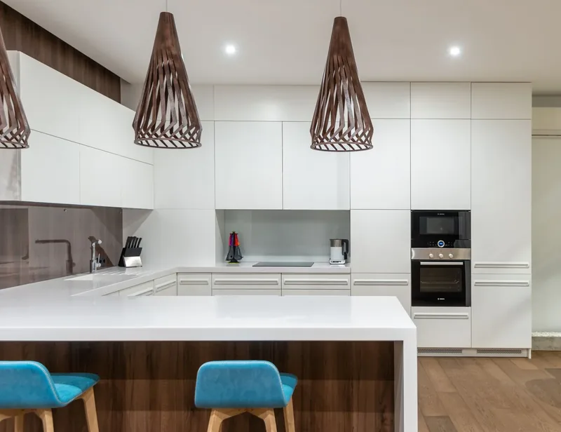A white kitchen with stone worktops