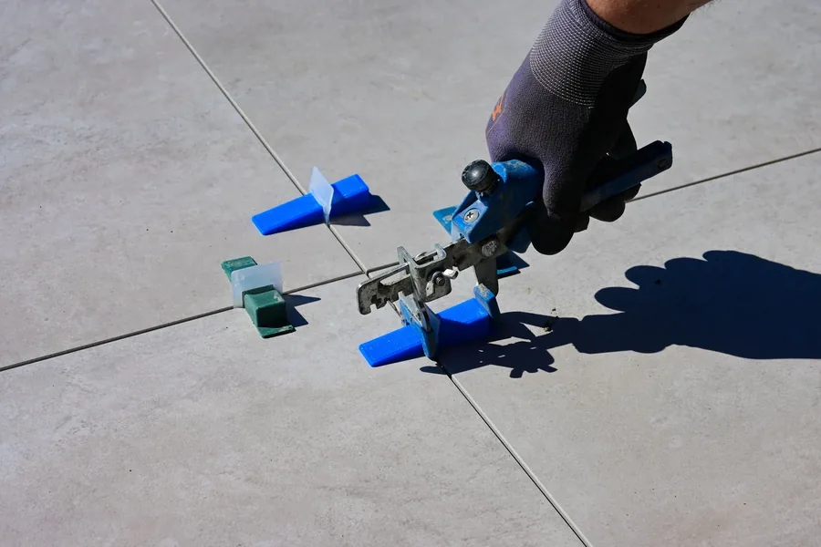 Floor tiles being levelled with clips